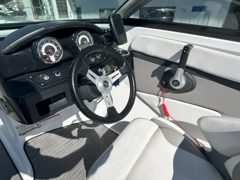 Slide: The Image of 2021 Four Winns HD2 OB boat dashboard with steering wheel and controls. - 7
