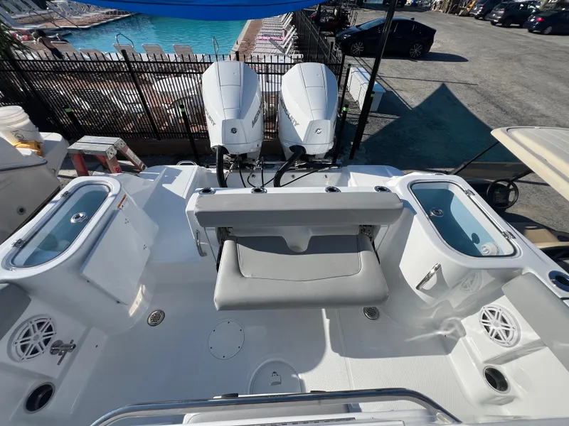 Slide: The Image of 2026 Wellcraft 243 Fisherman boat interior with dual Mercury engines, live wells, and seating. - 10