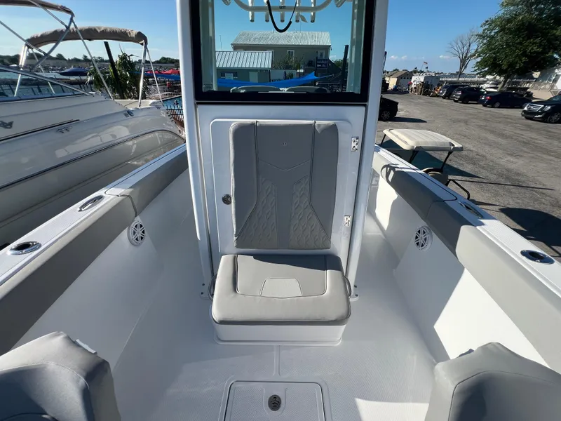 Slide: The Image of 2026 Wellcraft 243 Fisherman boat interior with seating and storage compartments. - 17