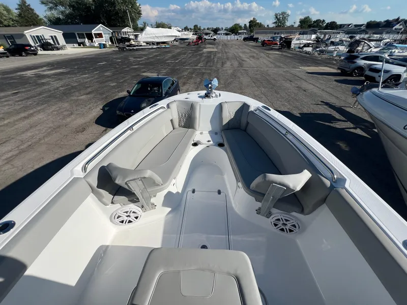 Slide: The Image of 2026 Wellcraft 243 Fisherman boat with spacious seating, docked at a marina. - 19