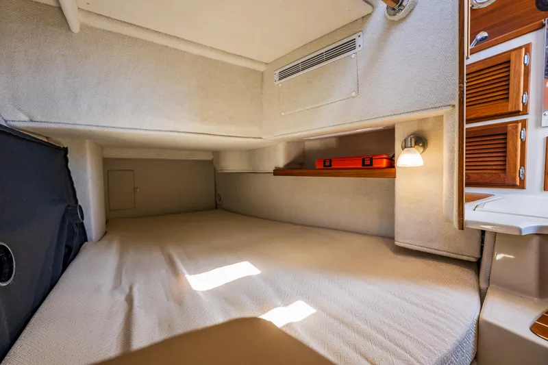 Slide: The Image of 2021 Ranger Tugs R-31 CB cabin interior with bed, storage, and lighting. - 12