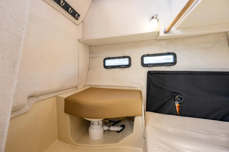 Slide: The Image of Interior cabin of 2021 Ranger Tugs R-31 CB with seating and portholes. - 13