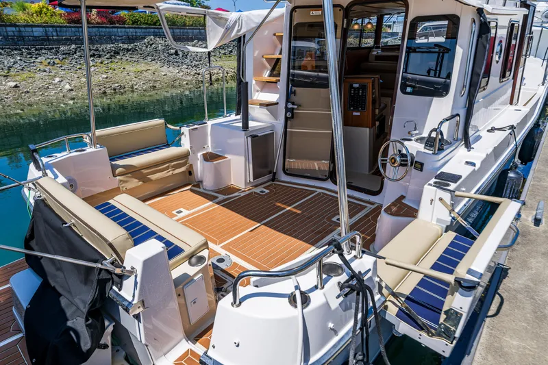 Slide: The Image of 2021 Ranger Tugs R-31 CB boat interior with seating and steering wheel. - 15