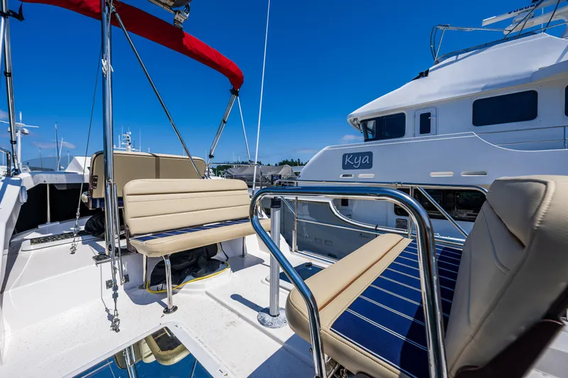 Slide: The Image of 2021 Ranger Tugs R-31 CB boat deck with seating, blue sky background. - 23