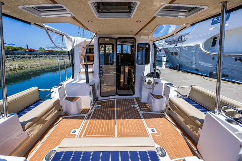 Slide: The Image of 2021 Ranger Tugs R-31 CB boat interior with seating and wood flooring. - 24