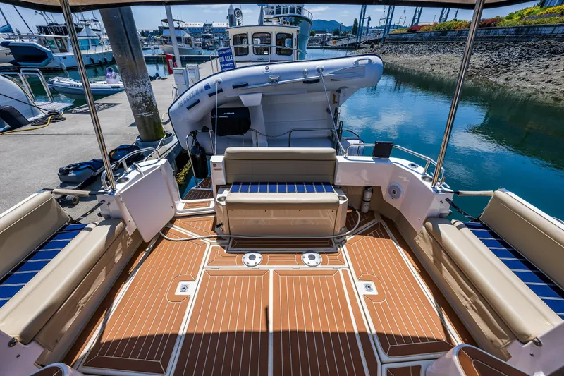 Slide: The Image of 2021 Ranger Tugs R-31 CB boat interior with seating and wood deck at marina. - 25