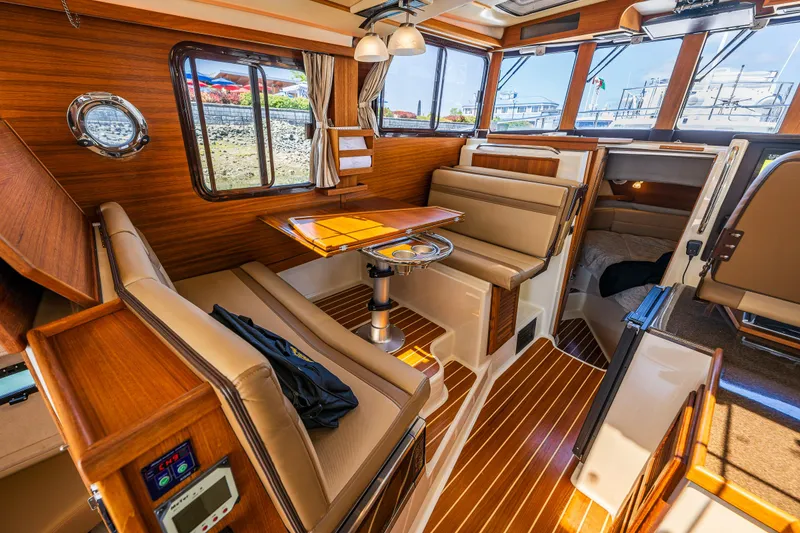 Slide: The Image of Luxurious interior of 2021 Ranger Tugs R-31 CB with wood finish and comfortable seating. - 26