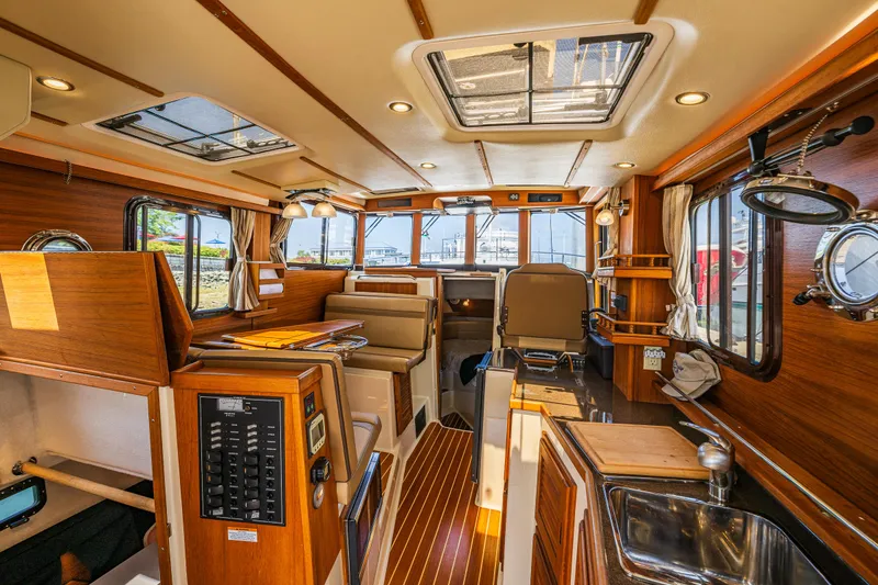 Slide: The Image of Interior of 2021 Ranger Tugs R-31 CB, featuring wood finishes and modern amenities. - 30