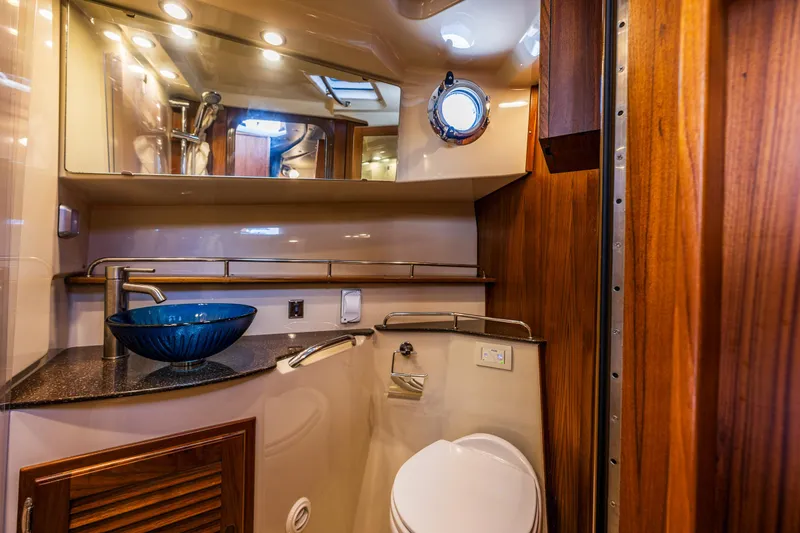 Slide: The Image of Luxurious bathroom in 2021 Ranger Tugs R-31 CB with modern fixtures and elegant wood accents. - 35