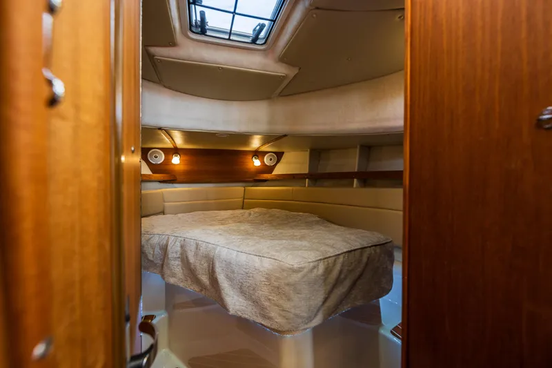 Slide: The Image of 2021 Ranger Tugs R-31 CB cabin interior with cozy bed and ambient lighting. - 36