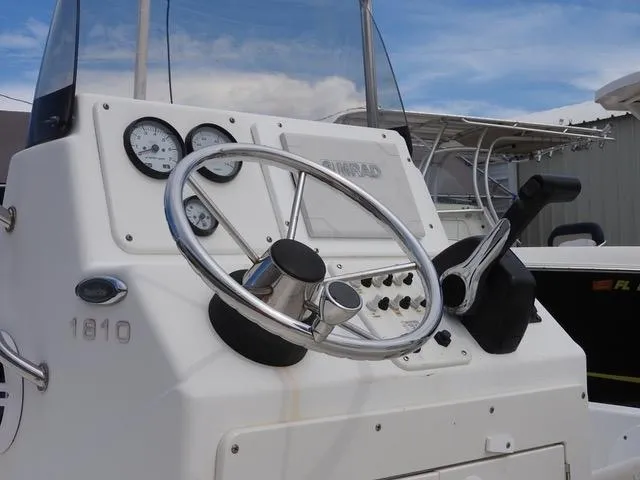 Slide: The Image of 2009 NauticStar 1810 Nautic Bay boat dashboard with steering wheel and gauges. - 6