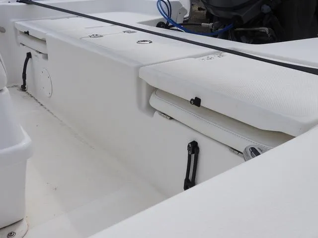 Slide: The Image of 2009 NauticStar 1810 Nautic Bay boat interior with seating and storage compartments. - 9