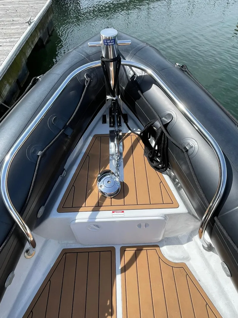 Slide: The Image of 2021 Protector 330 Targa boat bow with teak flooring and anchor system. - 17