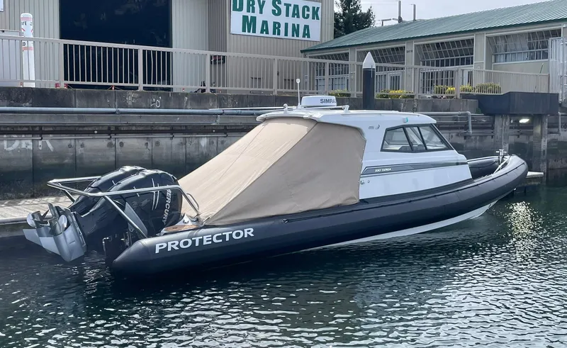 Slide: The Image of 2021 Protector 330 Targa boat with twin Mercury 350 HP engines docked at marina. - 23