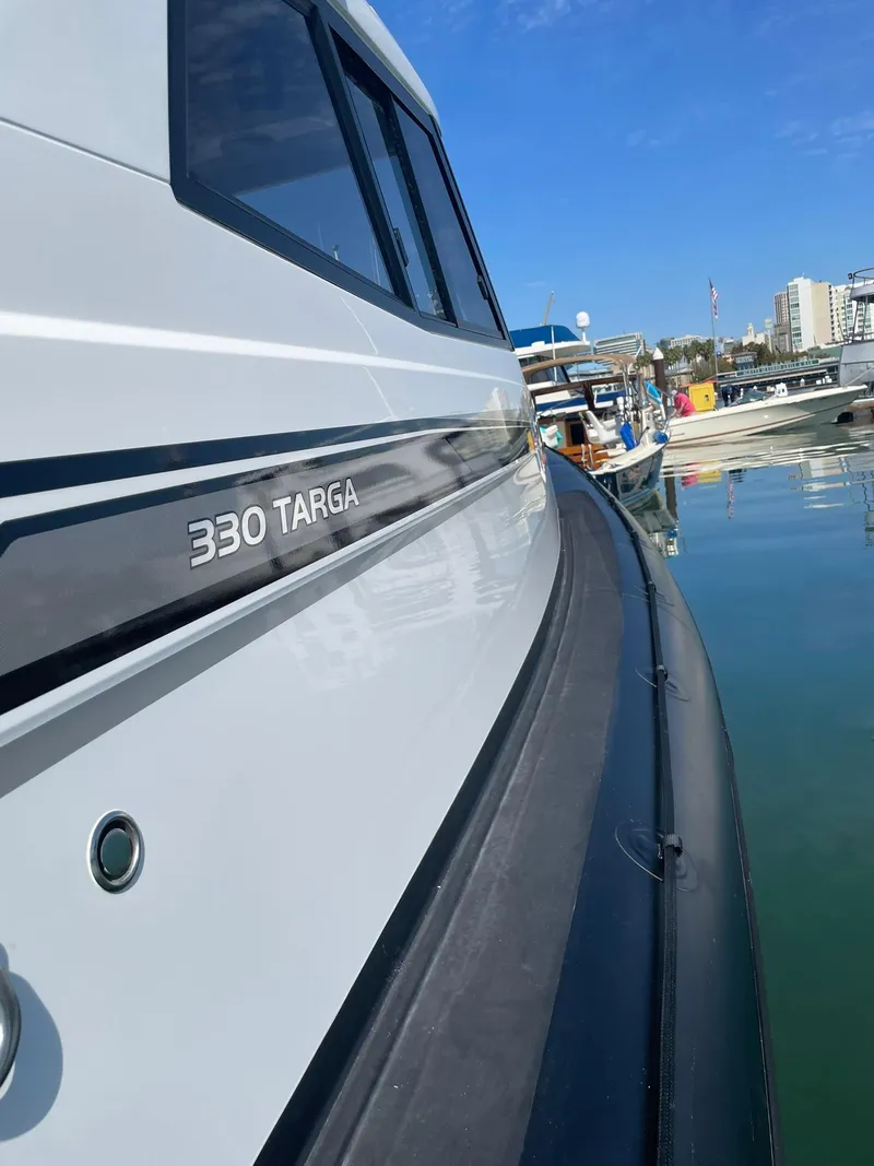 Slide: The Image of Protector 330 Targa boat docked, showcasing sleek design and modern features. - 6