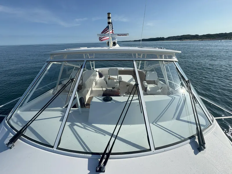 Slide: The Image of 2007 Viking 52 Open yacht on calm sea, showcasing sleek design and spacious deck. - 11