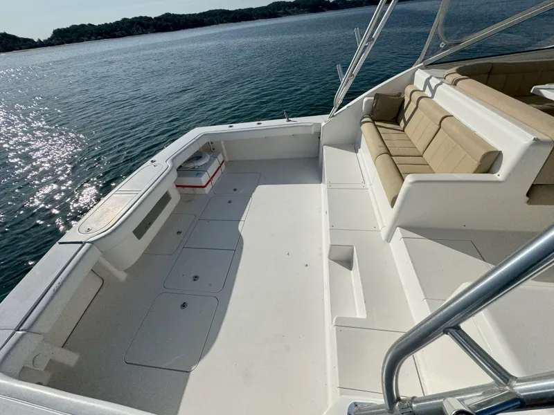 Slide: The Image of 2007 Viking 52 Open yacht deck with seating, overlooking calm waters. - 15