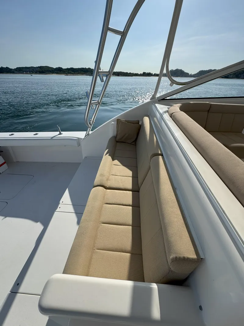 Slide: The Image of 2007 Viking 52 Open yacht interior with beige seating, overlooking calm waters. - 16