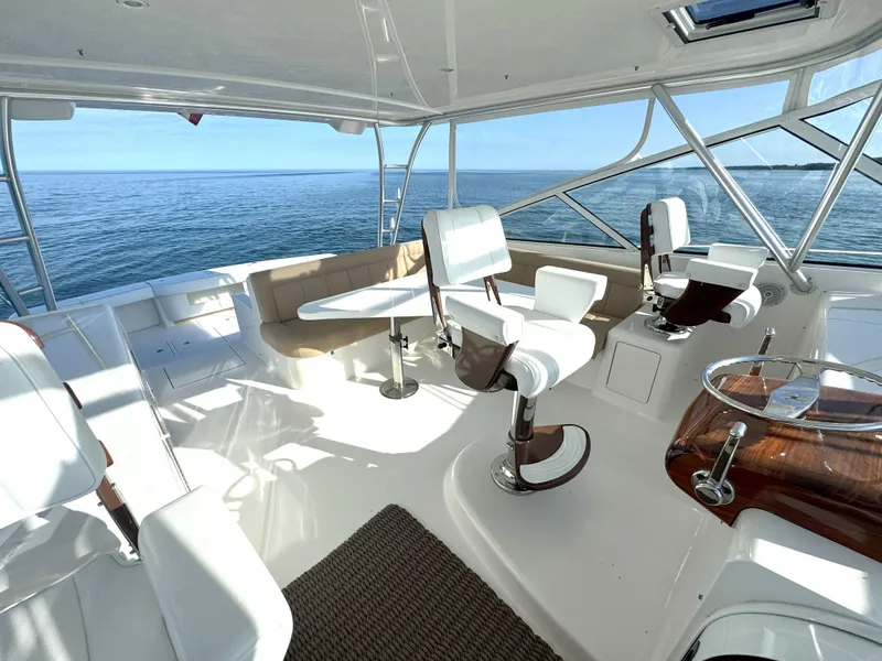 Slide: The Image of Luxurious 2007 Viking 52 Open yacht interior with white seating and ocean view. - 25