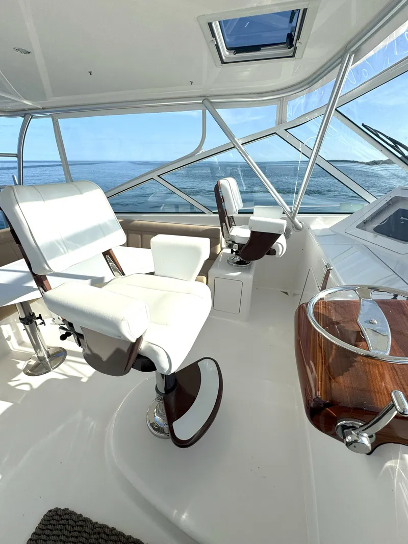Slide: The Image of Interior of 2007 Viking 52 Open yacht with white captain chairs and ocean view. - 27
