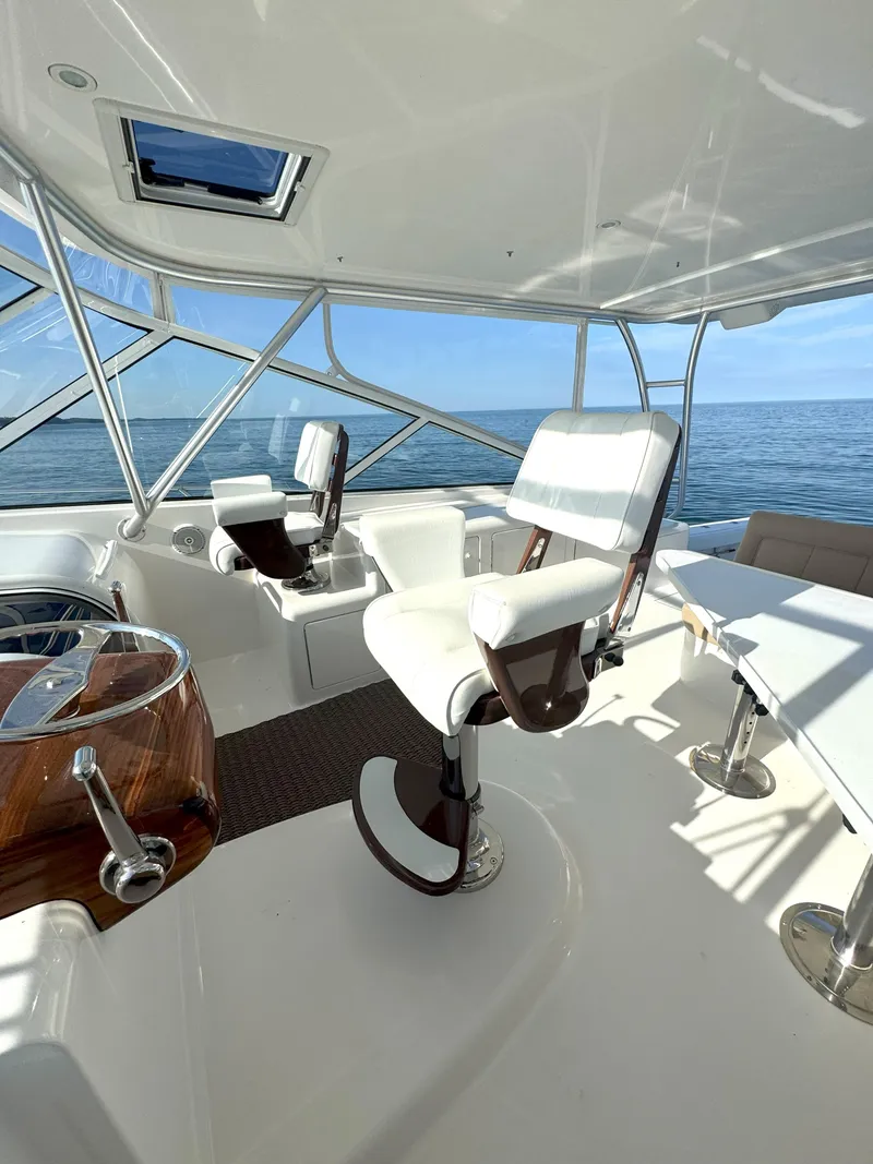 Slide: The Image of Luxurious interior of 2007 Viking 52 Open yacht with white seating and ocean view. - 28