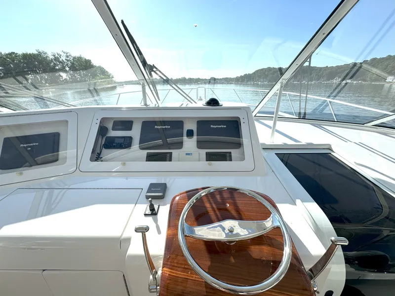 Slide: The Image of 2007 Viking 52 Open yacht helm with Raymarine navigation, overlooking serene waters. - 29