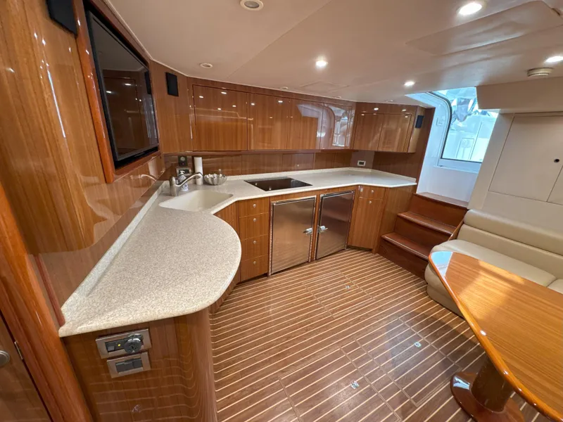 Slide: The Image of Luxurious 2007 Viking 52 Open yacht interior with modern kitchen and elegant wood finishes. - 42
