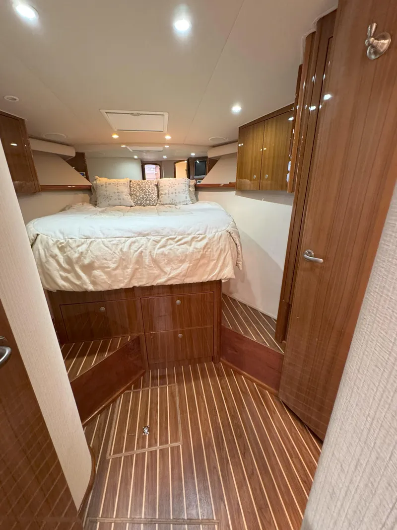 Slide: The Image of Luxurious cabin interior of 2007 Viking 52 Open yacht with wood finish and cozy bed. - 43