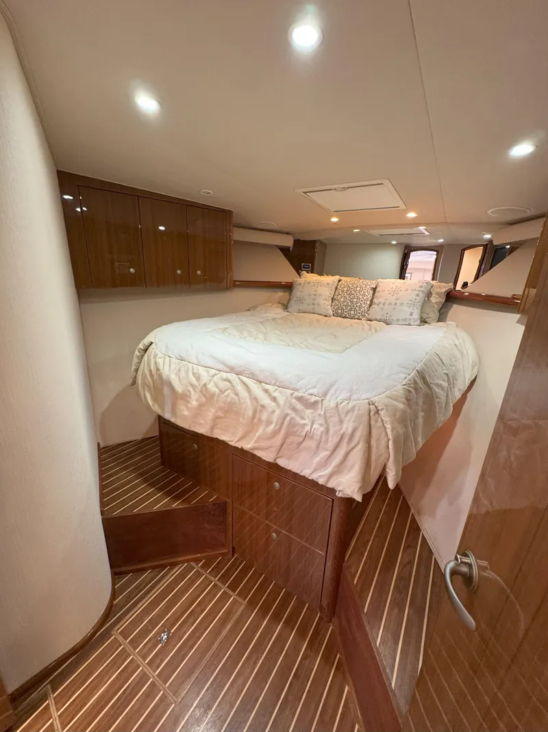 Slide: The Image of Luxurious bedroom interior of 2007 Viking 52 Open yacht with wooden flooring and cozy bedding. - 44
