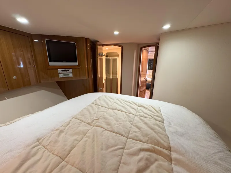 Slide: The Image of Luxurious cabin interior of 2007 Viking 52 Open yacht with cozy bedding and TV. - 45
