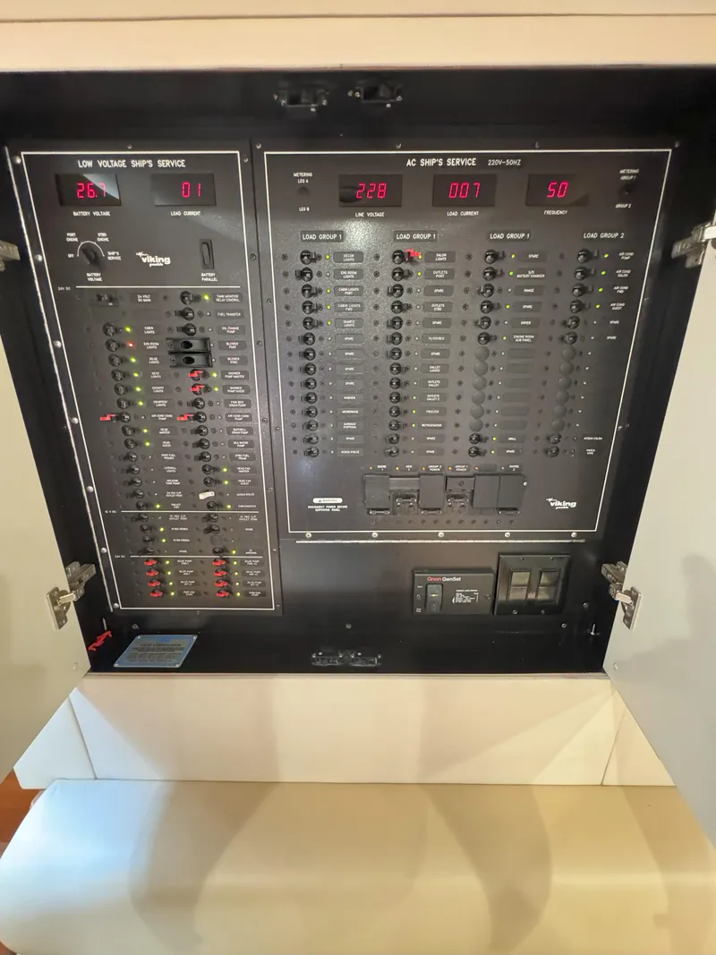 Slide: The Image of Electrical panel of a 2007 Viking 52 Open boat, showcasing control switches and indicators. - 49