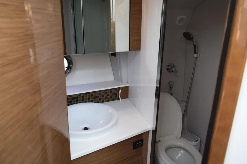 Slide: The Image of Bathroom interior of 2018 Cruisers Yachts 45 Cantius, featuring sink, toilet, and shower. - 16