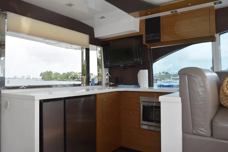 Slide: The Image of Interior of 2018 Cruisers Yachts 45 Cantius with modern kitchen and scenic window view. - 21