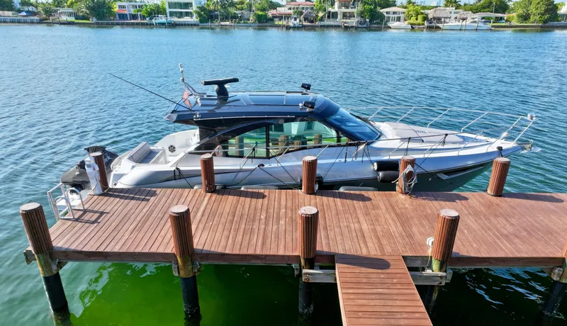 Slide: The Image of 2018 Cruisers Yachts 45 Cantius docked on a serene waterfront. - 25