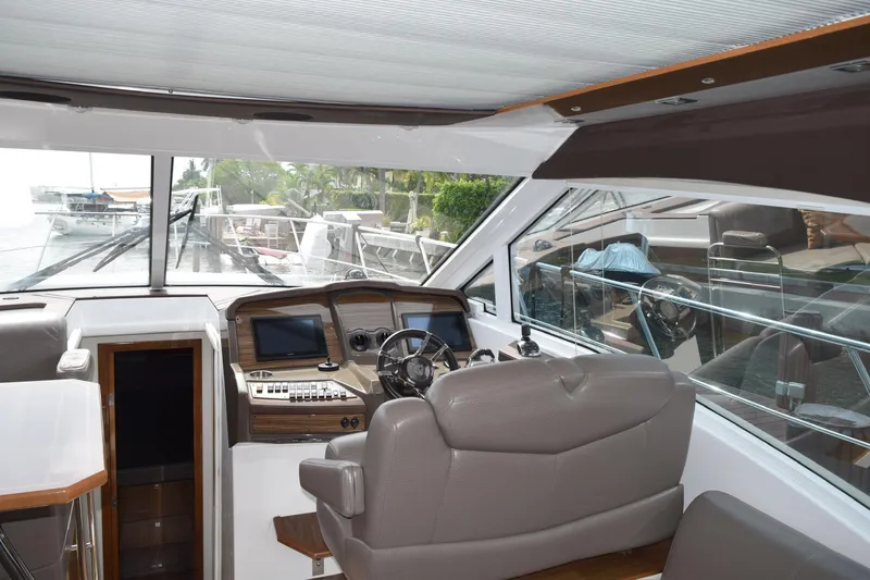 Slide: The Image of Interior view of 2018 Cruisers Yachts 45 Cantius helm with modern controls and seating. - 6