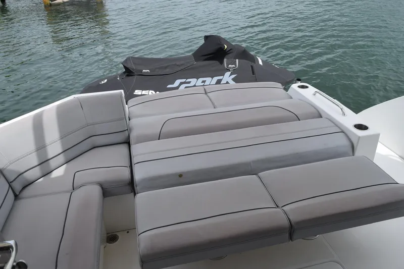Slide: The Image of 2018 Cruisers Yachts 45 Cantius with gray seating and Sea-Doo Spark on water. - 9