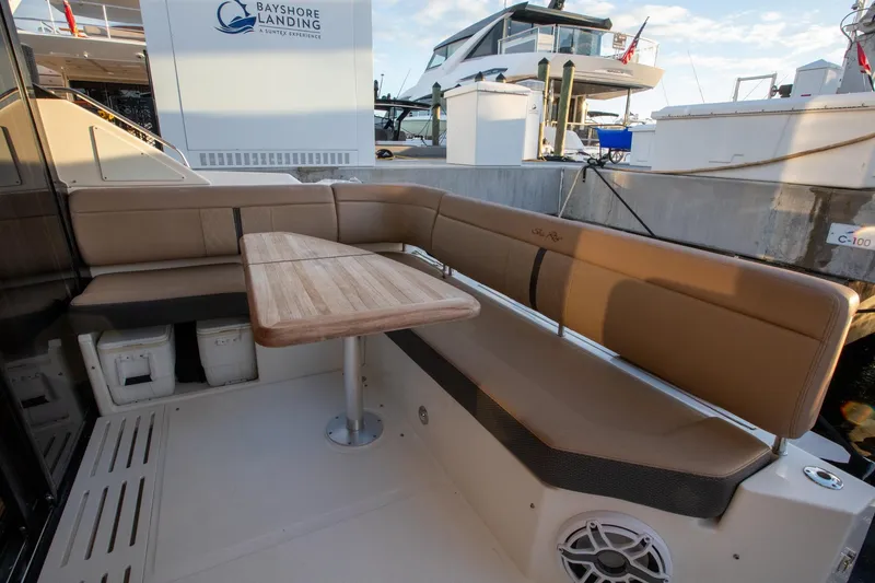Slide: The Image of 2018 Sea Ray Sundancer 400 yacht with outdoor seating and wooden table at Bayshore Landing. - 23