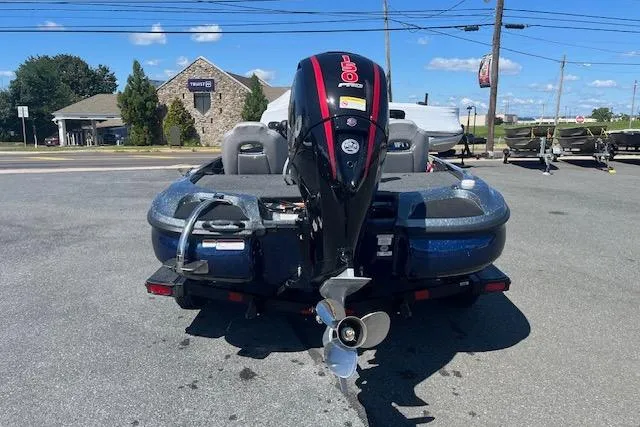 Slide: The Image of 2026 Nitro Z18 Pro boat with powerful outboard motor, parked outdoors on a sunny day. - 94