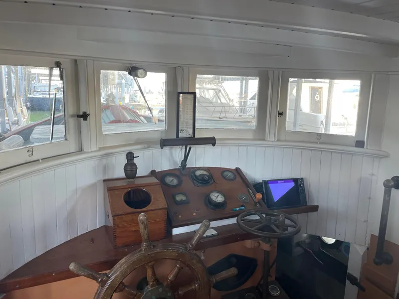 Slide: The Image of Interior of 1920 Blanchard Dunlin 42 boat with vintage steering wheel and navigation instruments. - 13