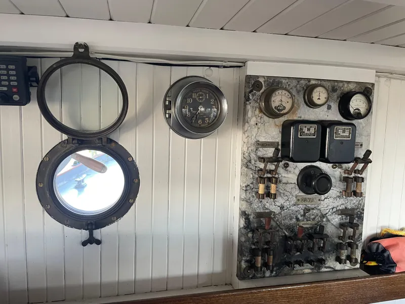 Slide: The Image of 1920 Blanchard Dunlin 42 interior with vintage gauges and porthole. - 16