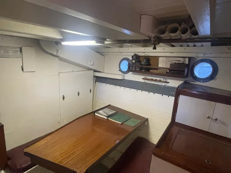 Slide: The Image of Interior of 1920 Blanchard Dunlin 42 boat with wooden table and portholes. - 17