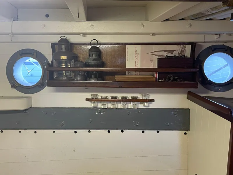 Slide: The Image of Interior of 1920 Blanchard Dunlin 42 with portholes, lanterns, and nautical decor. - 18