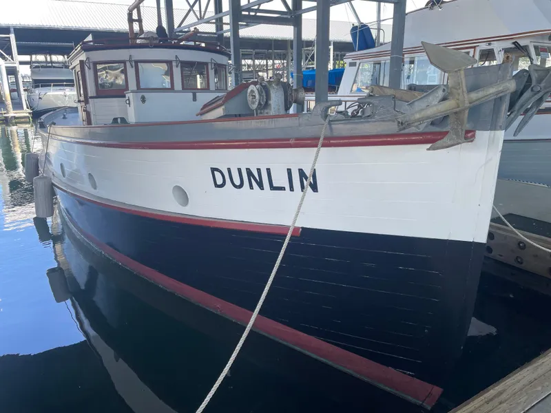 Slide: The Image of Vintage 1920 Blanchard Dunlin 42 boat docked in marina, showcasing classic design. - 3