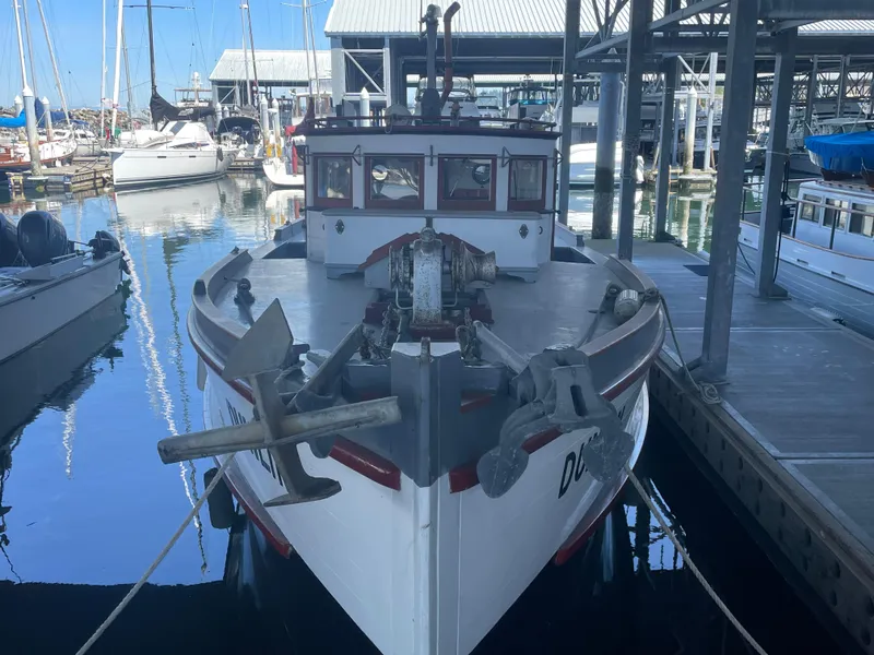 Slide: The Image of Vintage 1920 Blanchard Dunlin 42 boat docked in a marina, showcasing its classic design. - 4