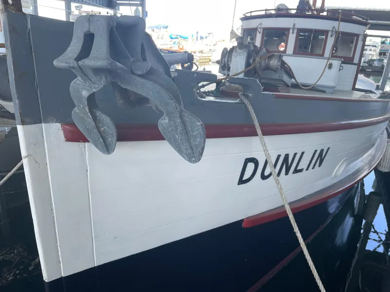Slide: The Image of Vintage Blanchard Dunlin 42 boat from 1920, docked with visible anchor and nameplate. - 5