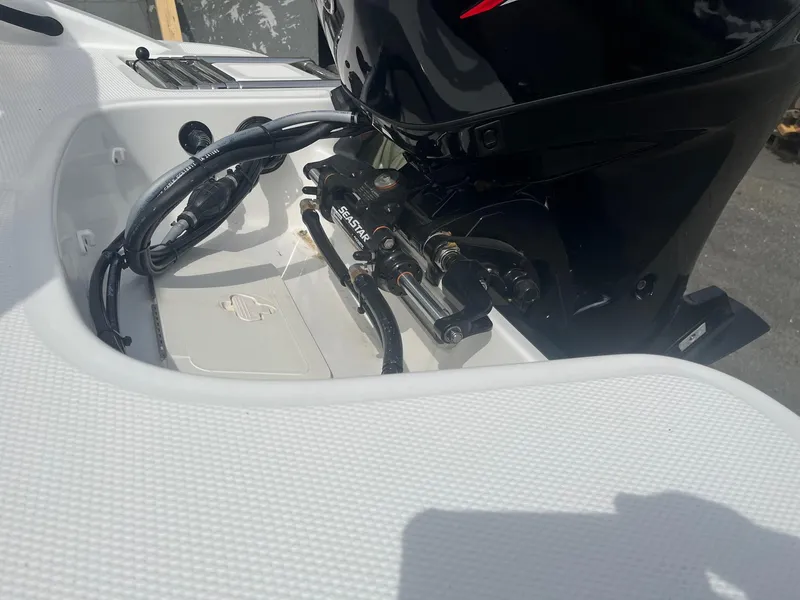 Slide: The Image of 2025 Tahoe T16 boat engine compartment with SeaStar hydraulic steering system. - 3