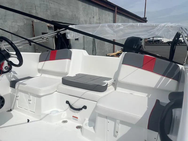 Slide: The Image of 2025 Tahoe T16 boat interior with white and gray seating, red accents, and steering wheel. - 4