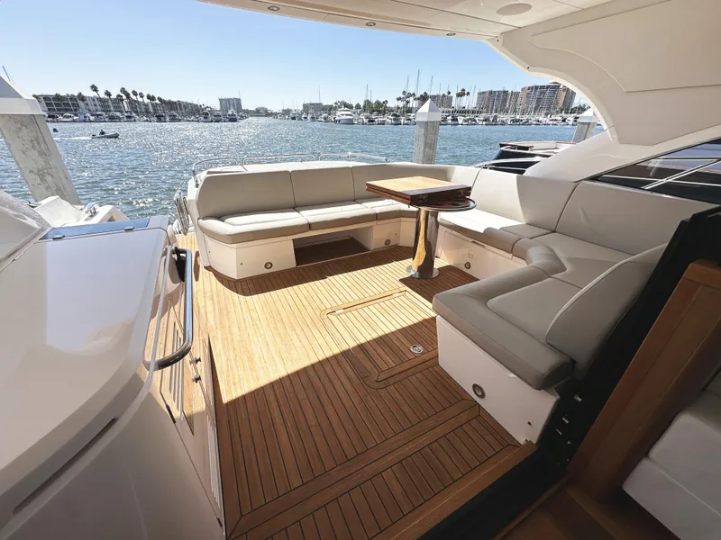 Slide: The Image of Luxurious 2019 Sunseeker Predator 57 yacht deck with elegant seating and scenic marina view. - 12