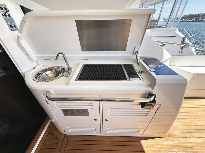 Slide: The Image of Outdoor kitchen on 2019 Sunseeker Predator 57 yacht with sink and grill. - 14
