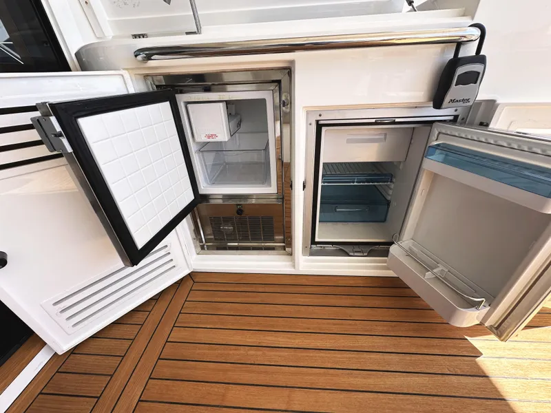 Slide: The Image of Sunseeker Predator 57 yacht, 2019 model, featuring open refrigerators on teak deck. - 16